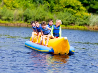 Mariner campers riding a banana boat.