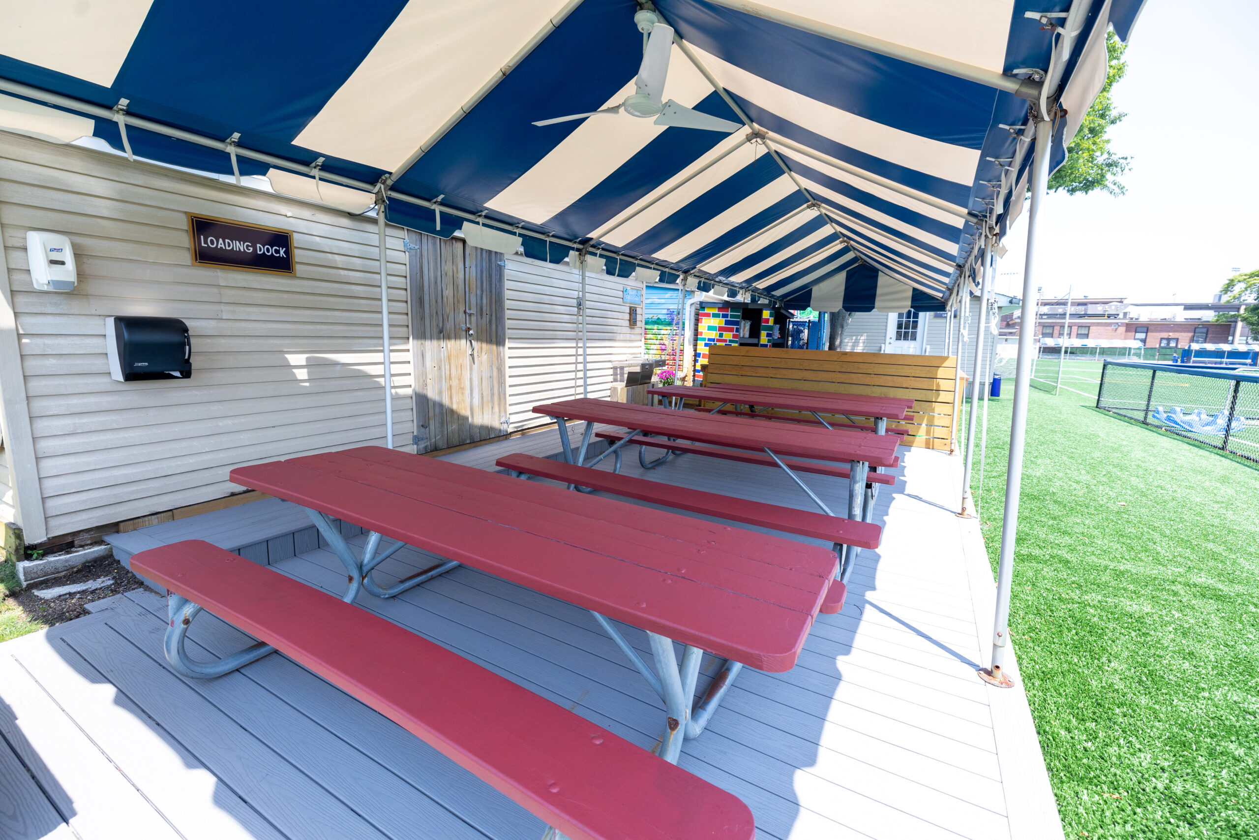 Maroon picnic tables.
