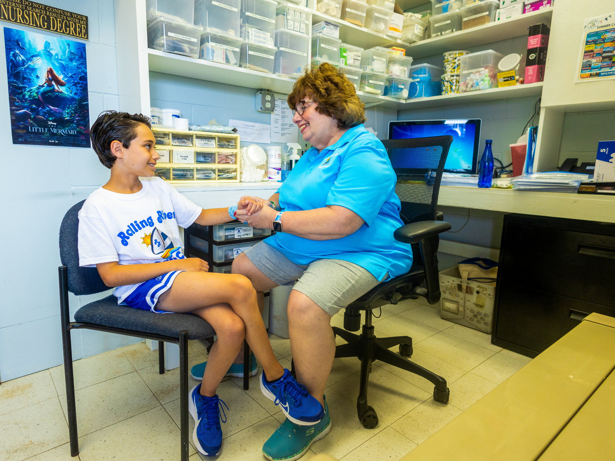 A nurse taking care of a camper.
