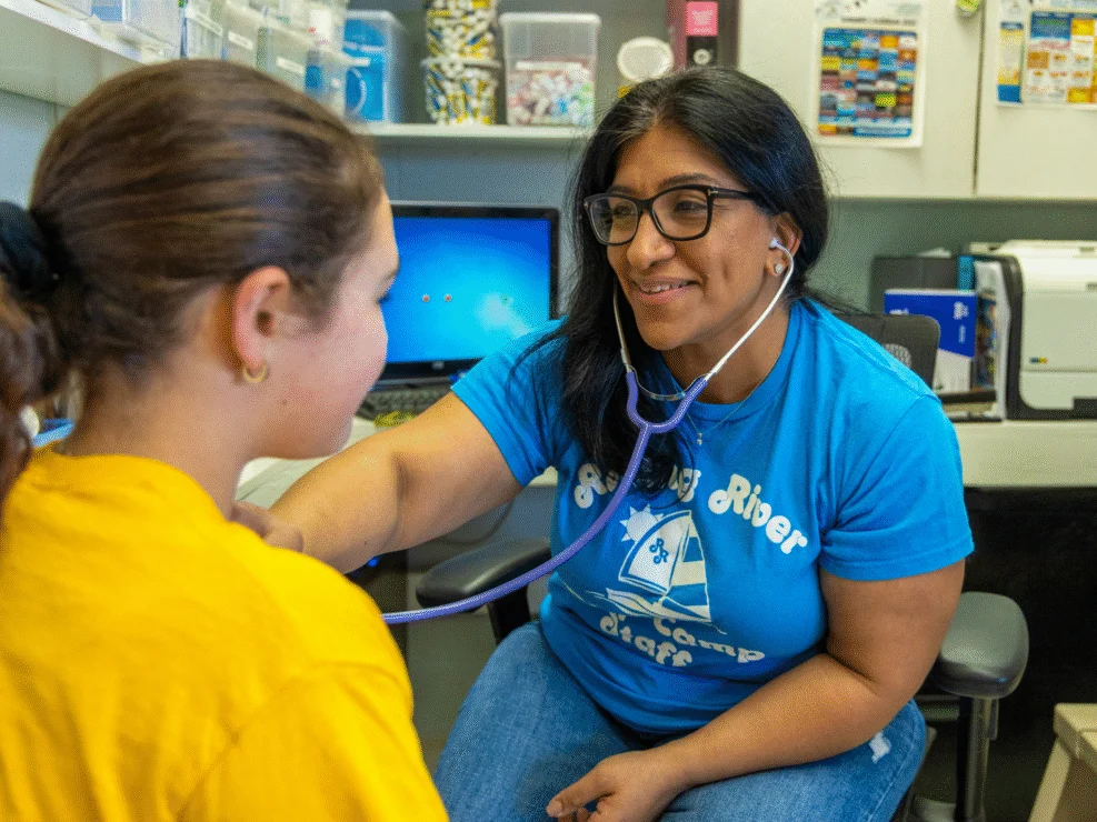 A nurse using a stethoscope.