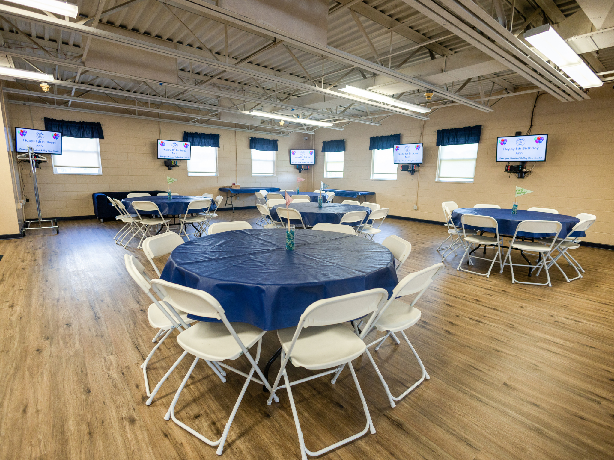 A room set up with circular dining tables.