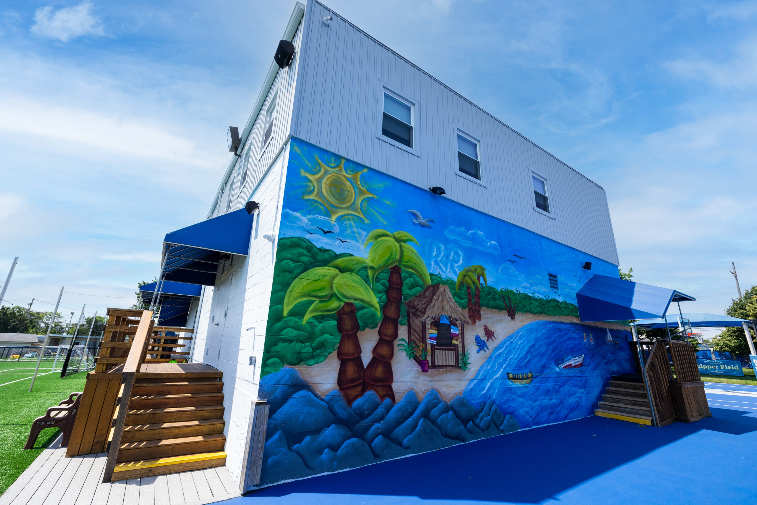 A building with a mural of a beach.