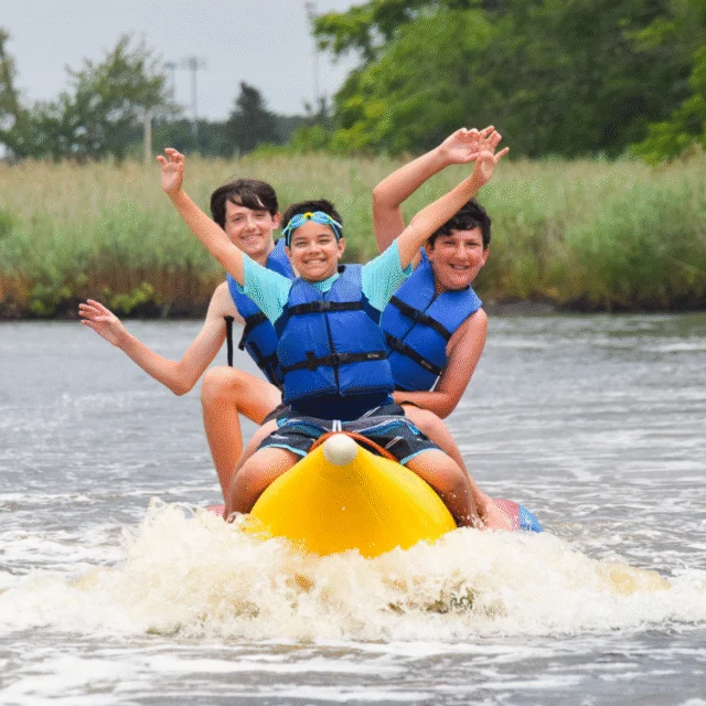 Three campers on a banana boat.