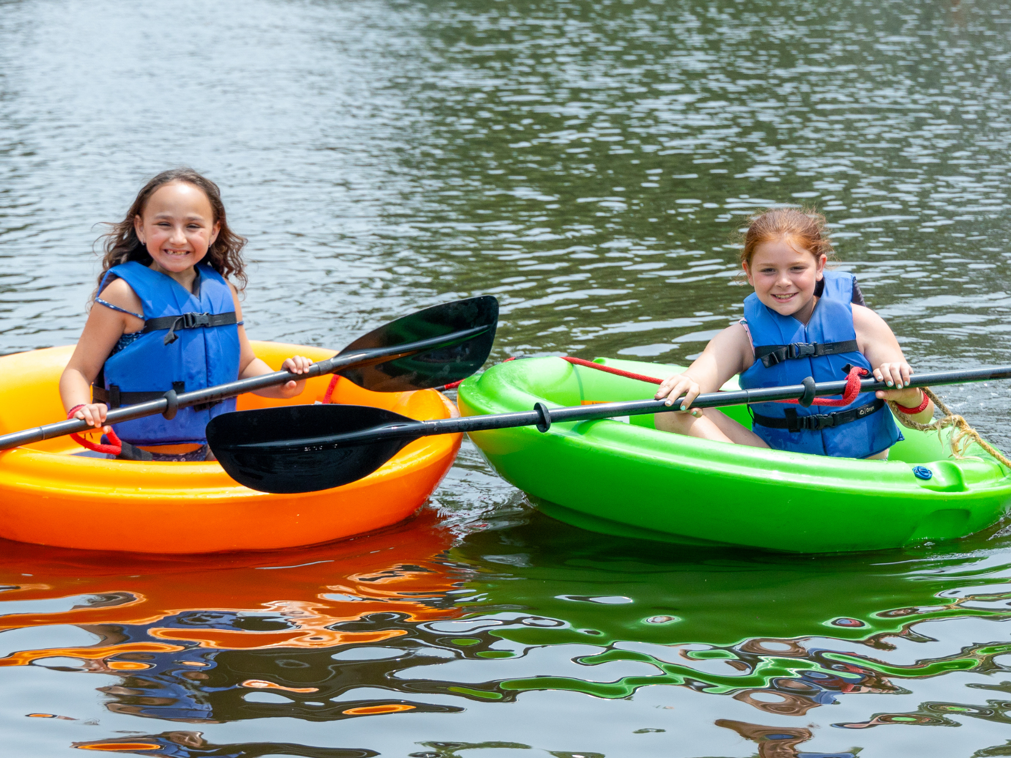 Two campers on a paddleboat.
