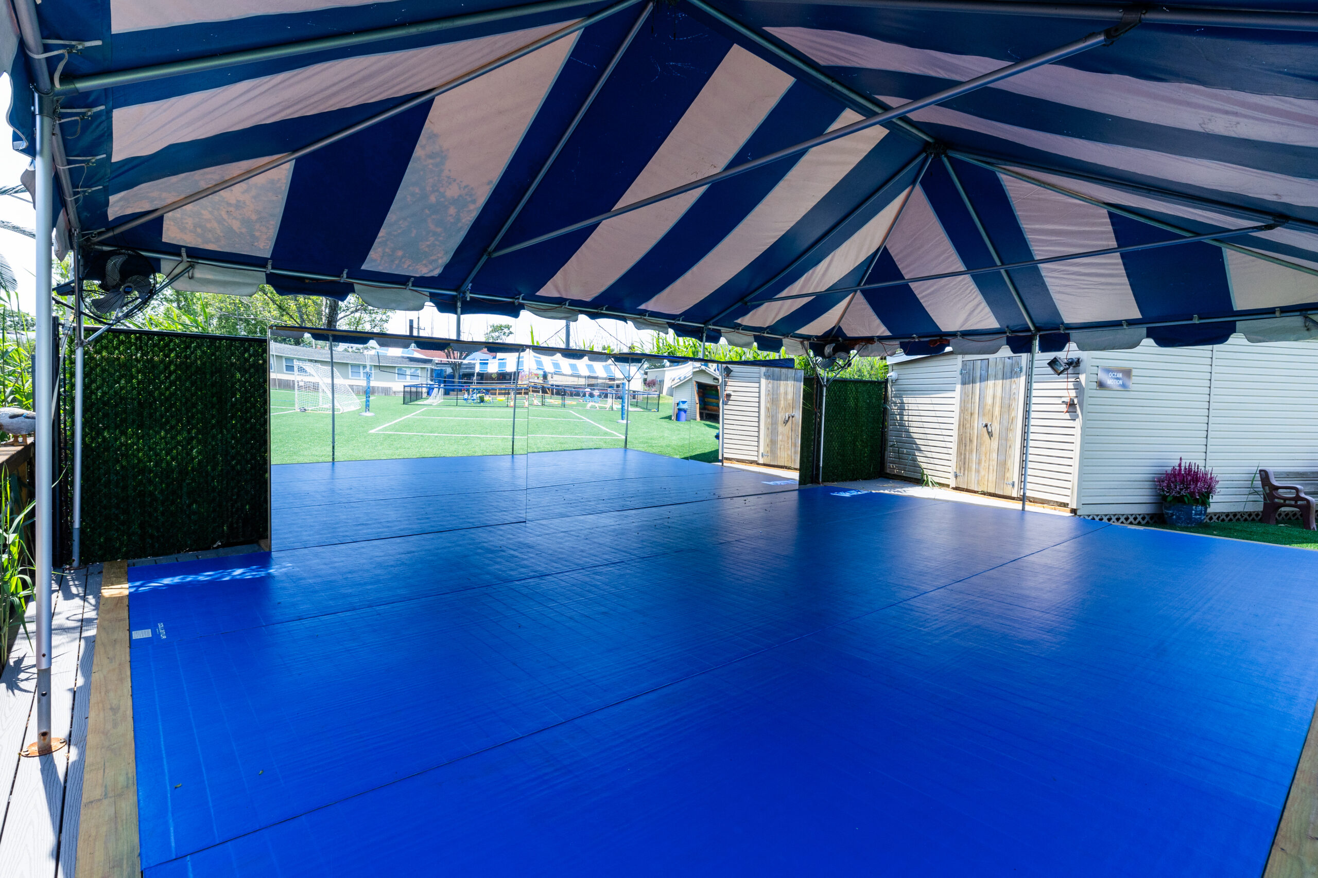 Riverside, tented deck that houses the dance program and martial arts program.
