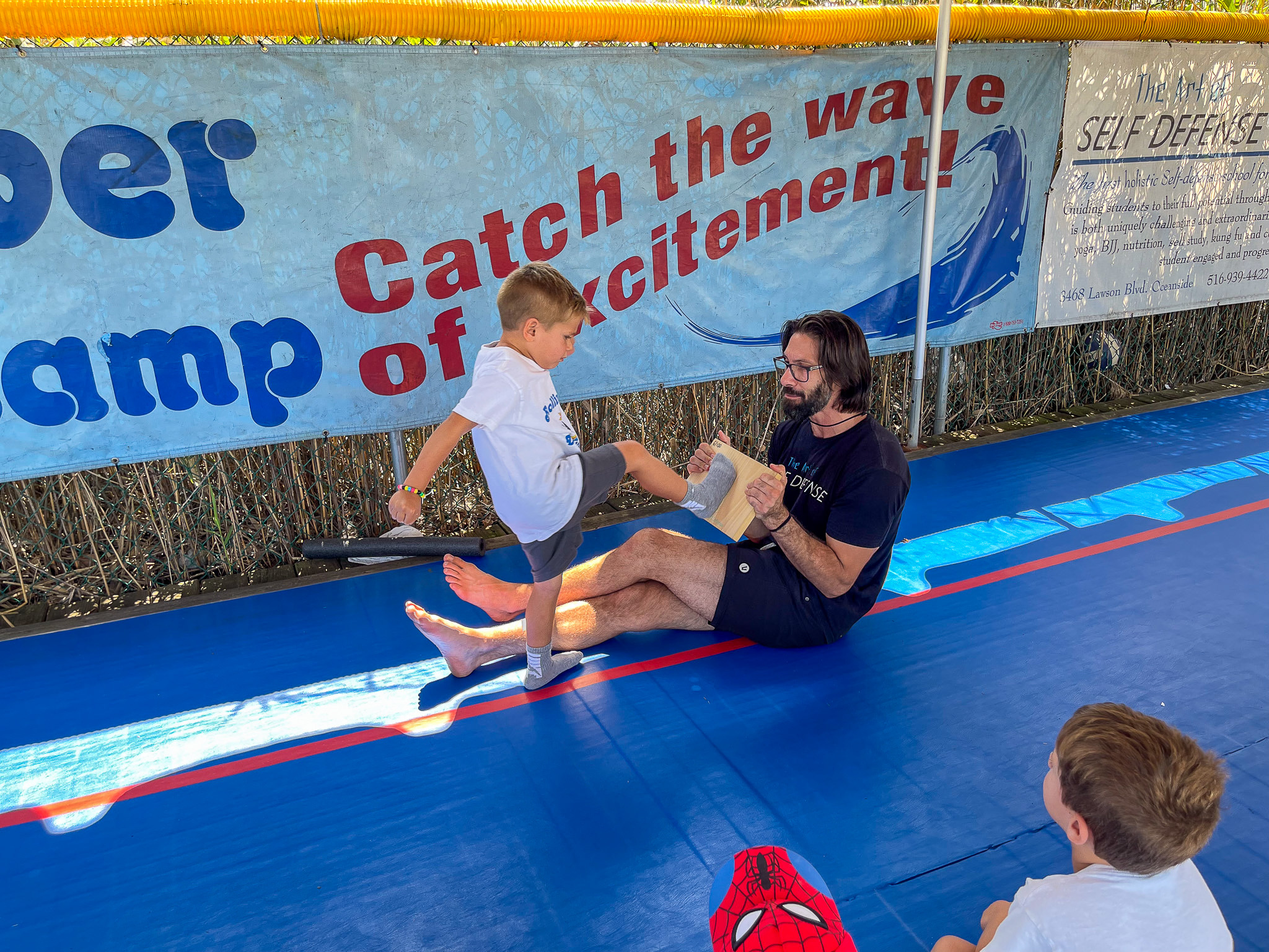 A camper practicing martial arts with an instructor.