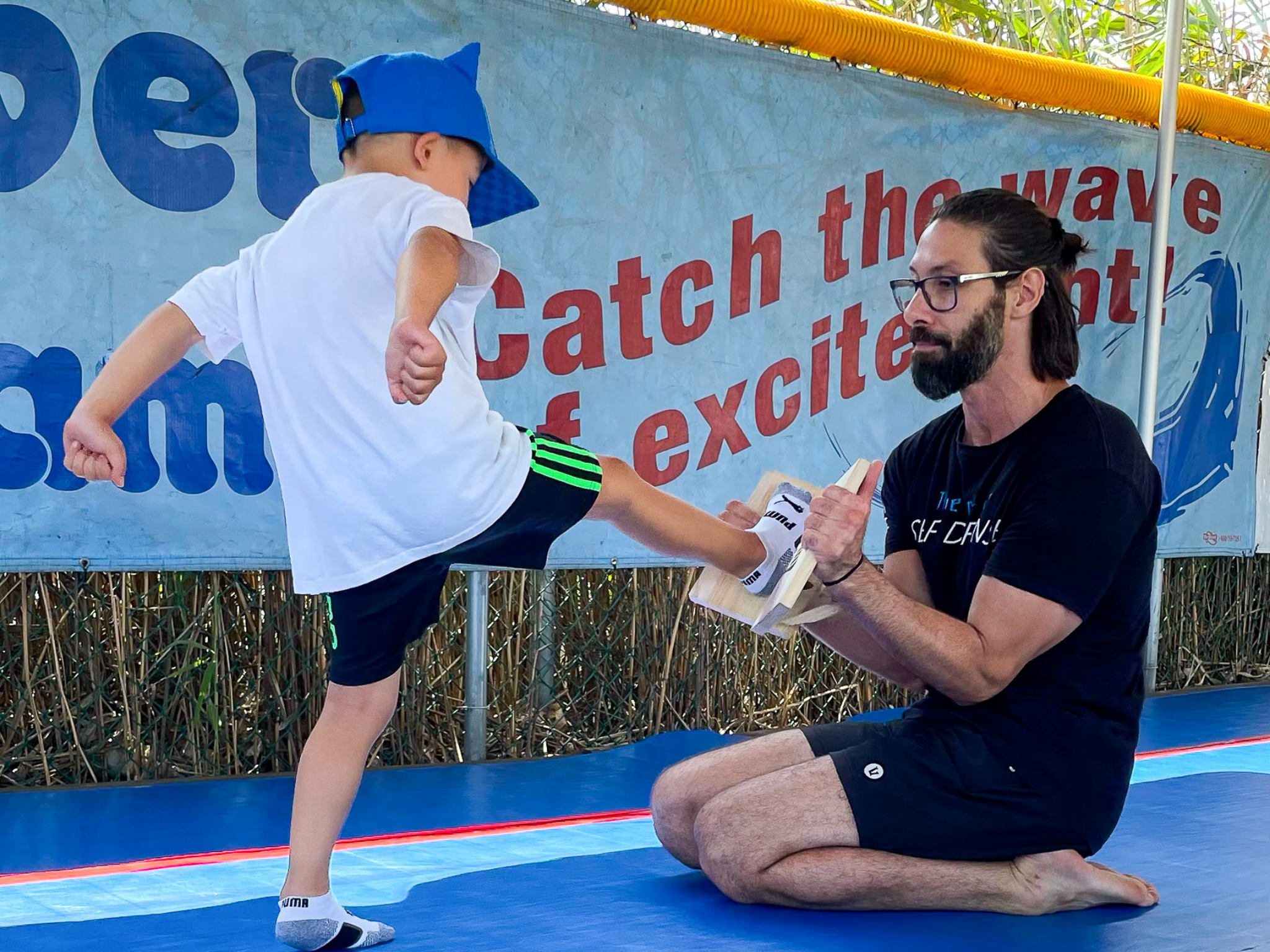A camper practicing martial arts with an instructor.
