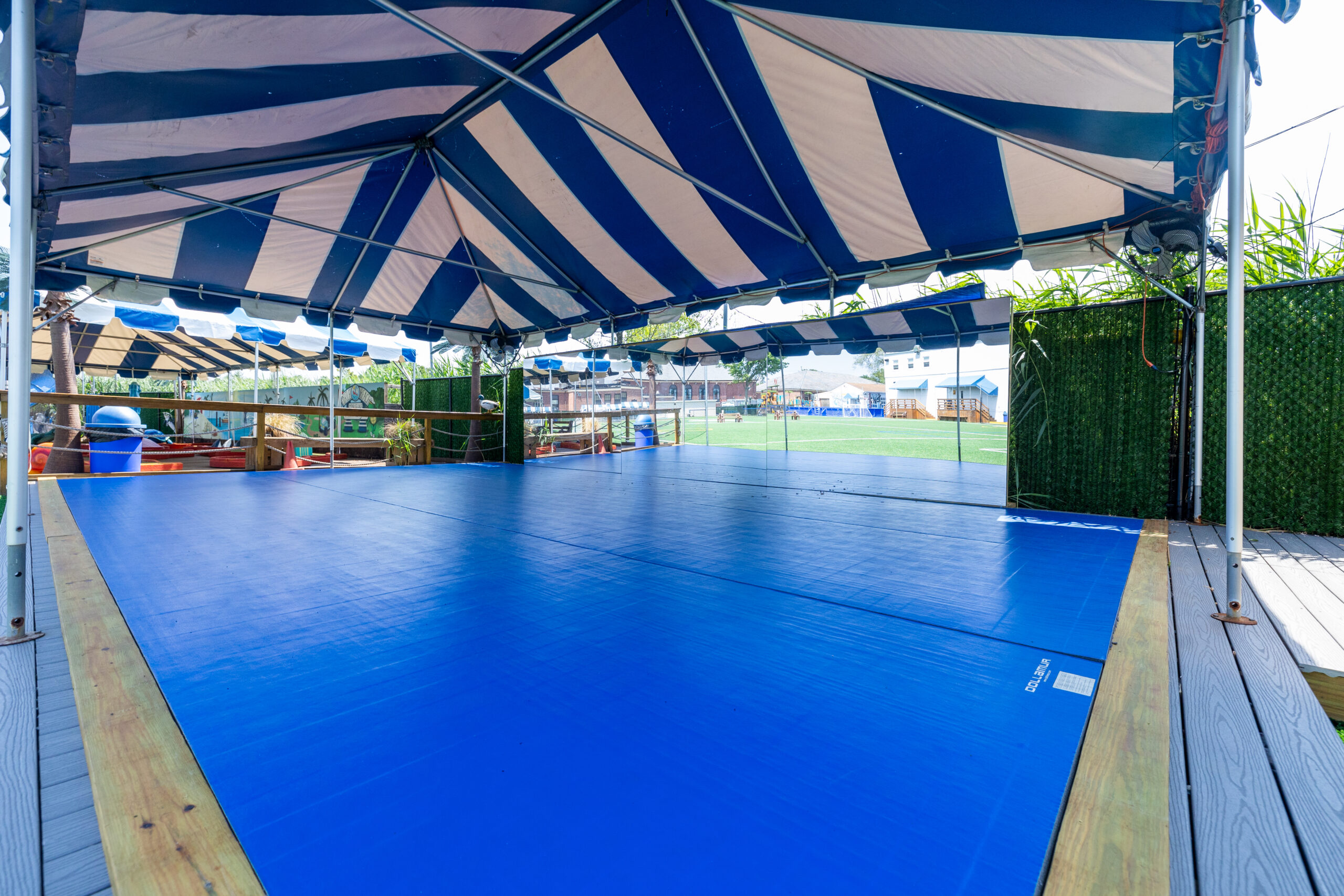 Riverside, tented deck that houses the dance program and martial arts program.