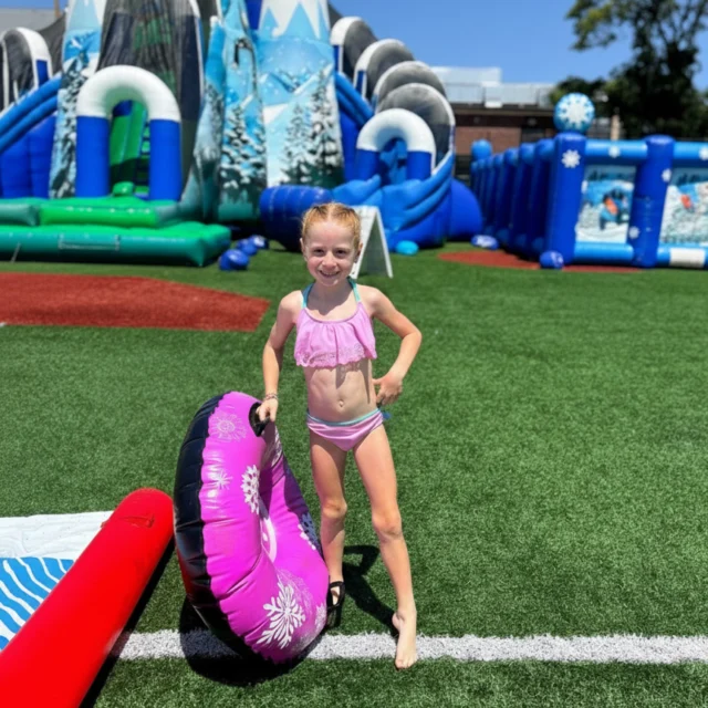 A camper holding an inflatable tube.