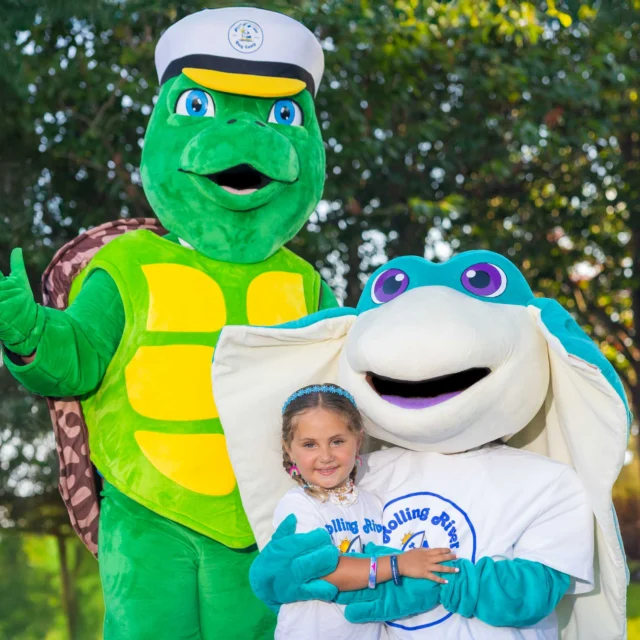 A camper with the mascots.