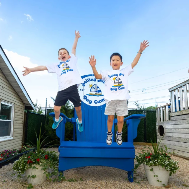 Two campers jumping happily.
