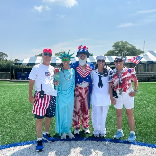 A group of camp staff dressed up for a festive event.