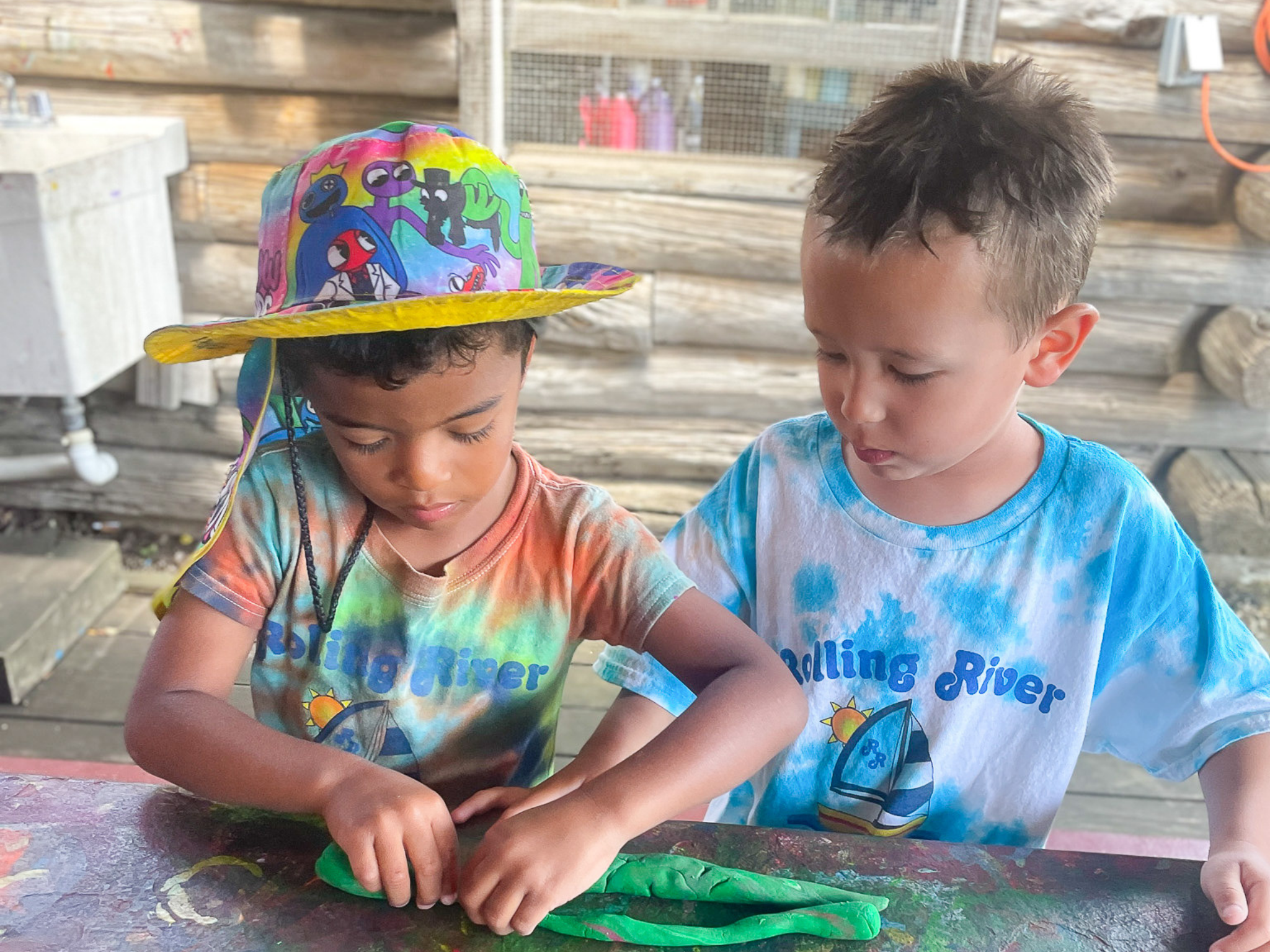 Two campers working on pottery.