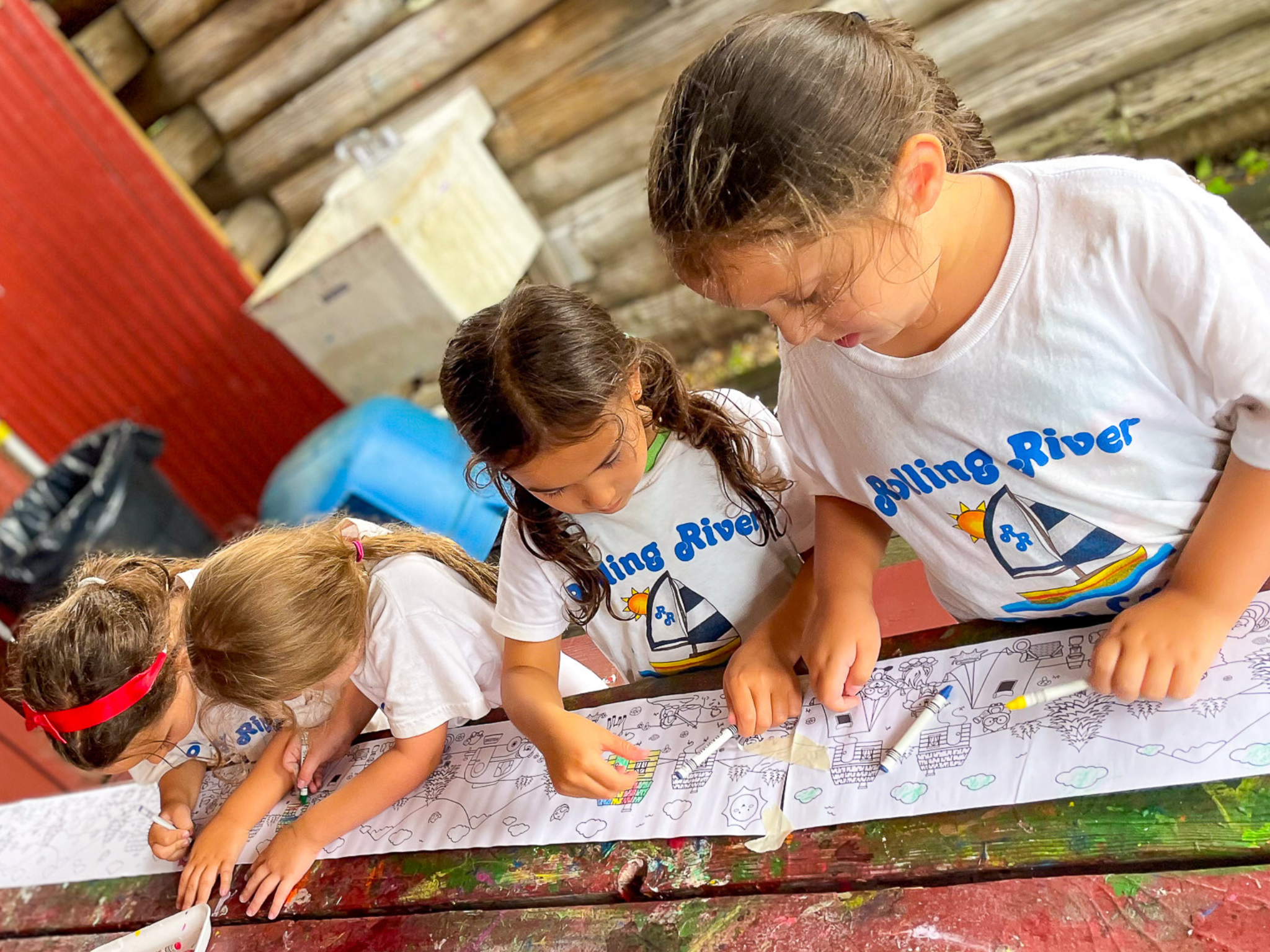Three campers working on pottery.