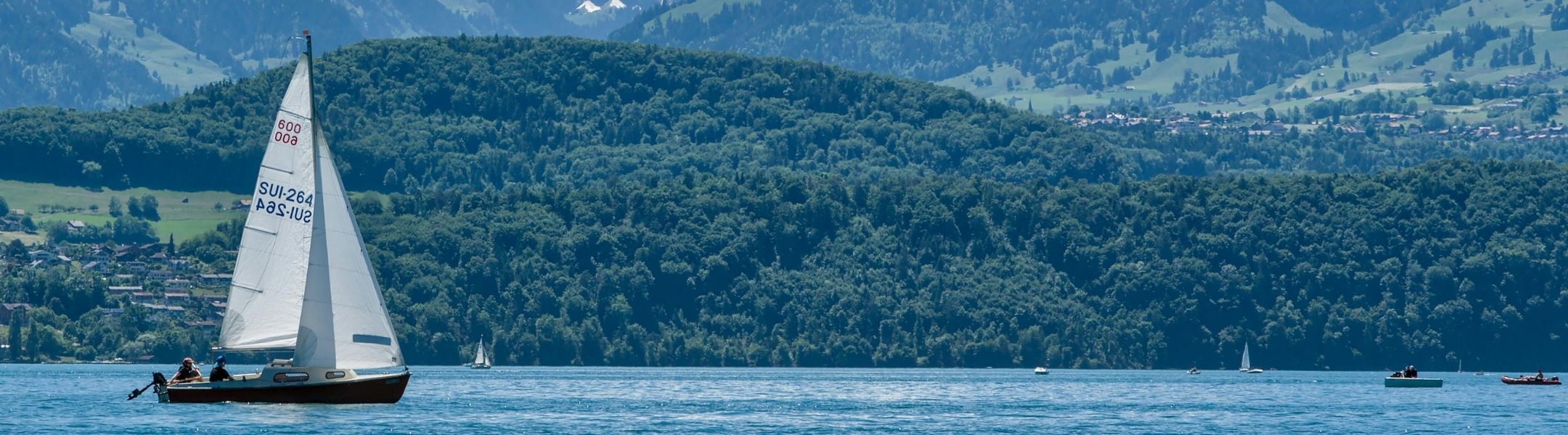 People sailing on sailboats