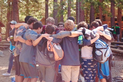 Group of boys hugging at camp