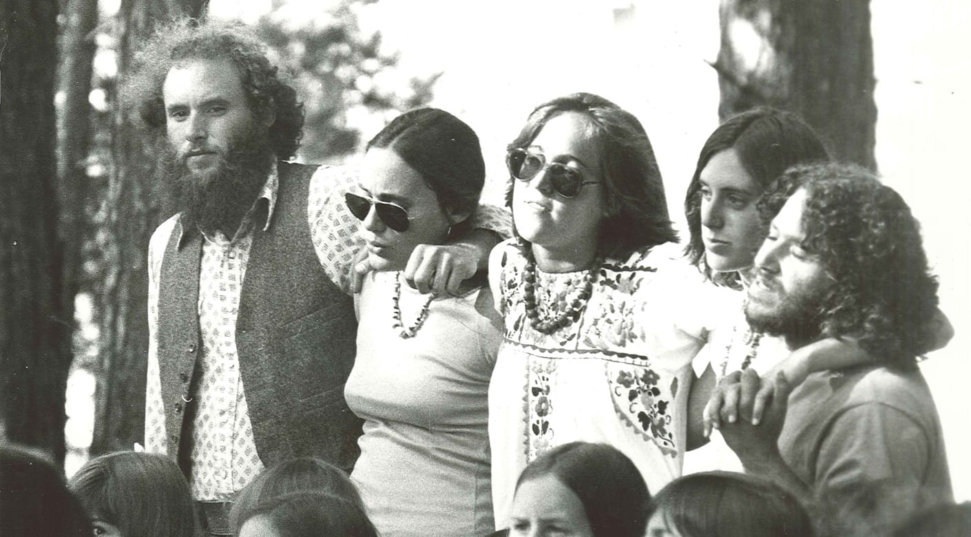 70s photo of four staff singing