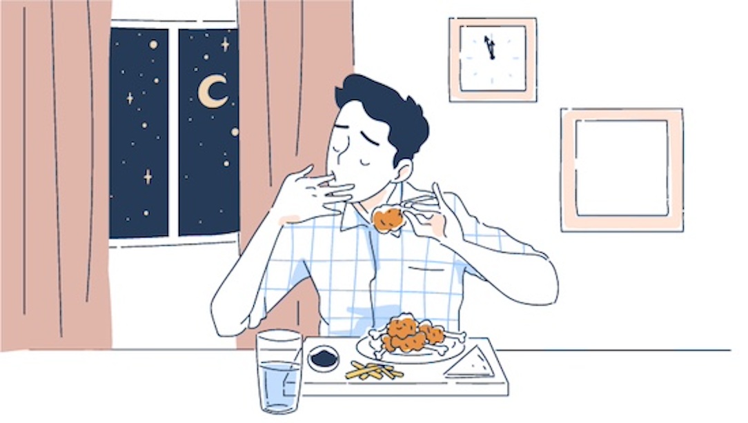 Man eating food at night.