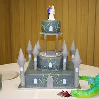 Castle Wedding wedding cake for my niece, dragon form is foil wrapped in fondant and airbrushed.