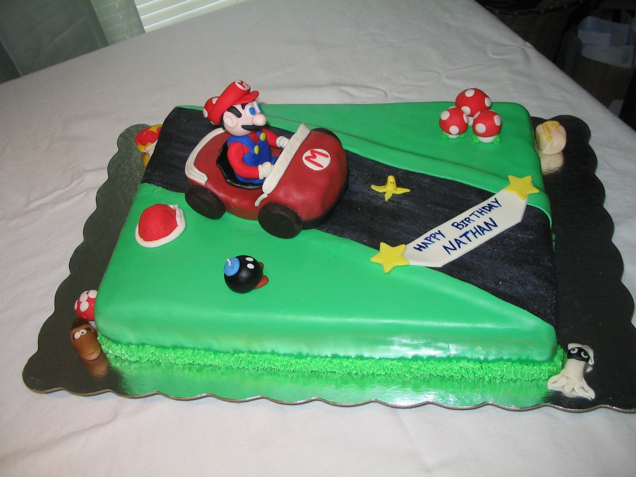 Mario Cart My son's 6th Bday cake, he wanted Mario Cart. Fondant, MMF & regular. Buttercream grass. My 8yr DD helped by molding some of the...