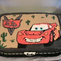 Cars Cake Yellow Cake with Vanilla Custard Filling. Iced in Buttercream with Dark Grey roan and Route 66 signs as the boarder. "Lightening...