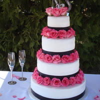 Rose Wedding Hidden pillar wedding cake with Med. Pink Roses. Smooth frosted buttercream cake