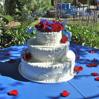 Sharon's July Wedding White smooth frosted buttercream frosted cake. I created the flower arrangement on the top. The design on the side was from Jaques'...