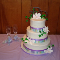 Tabitha's Dream Smooth frosted buttercream cake with ribbon matching invitations. Gumpaste flowers to match colored by me. I didn't make these this...