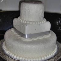 Yolie's 25Th Aniversary This is a vanilla cake with amaretto syrup, buttercream topped with almond fondant. 10-in round, 5 -in square, 4 -in round. Made for my...