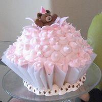 Teddy Bear Cupcake Cake Teddy bear topper modeled after Wilton's 2009 cover. Cupcake "liner" made out of parchment.