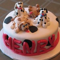 Dogs Cake covered in fondant. Dogs made of fondant for 4th birthday (one dog for each year).