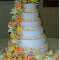 My_Cakes_053.jpg 6 tier round wedding cake 6,8,10,12,14,16 inches. Covered in ivory fondant with fresh flowers.