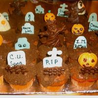 Graveyard Cupcakes Cupcake were yellow cake dyed orange with a green pudding filling. Topped with chocolate ganache and rolled in crushed chocolate graham...