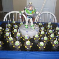 Buzz Lightyear And The Little Green Men Had some trouble with coming up with a buzz cake so here is what I did:Buzz is a toy on top of a 10 inch round cake covered in fondant....