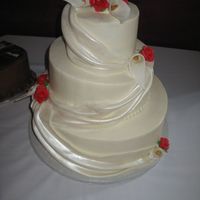 Img_0180.jpg iced in bc, fondant drapes painted with super pearl lustre, flowers made with fondant (i'm scared to try gumpaste)