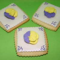 Pansy Cookies Sugar cookie with rbc. Dusted with violet pearl dust. Decorated with royal icing flower.