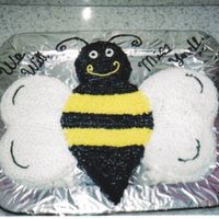 Bee Cake I used heart shaped pans for the wings, and round pans for the body and head.