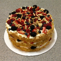 Chewy Italian Almond Cake With mascarpone cream filling, fresh berries, and toasted slivered almonds