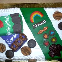 Girl Scout Cake Girl Scout Cake decorated with a box of samoas and thin mints with fondant cookie decorations and a fondant sash.