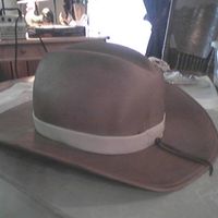 Cowboy Hat WASC cake crumb coated and filled with buttercream. Covered with fonfant and fondant brim. Airbrushed finish.