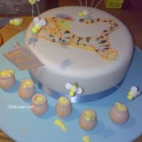 Tigger This cake was for a name giving. I painted tigger on with royal icing and then made the little bees on wire, honey pots( that spelt out his...