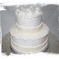 Small Wedding This was buttercreme icing witht he top layer Ghirardelli Chocolate Cake and the bottom Amaratto White. The border is MMF with pearl dust...