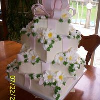 Wedding Gifts This is a four tier wedding cake covered in vanilla buttercream with fondant bow and buttercream flowers. Every tier was a different flavor...