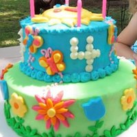 Butterflies & Flowers First cake using fondant for my daughter's 4th bday. Frosted in buttercream with MMF flowers, grass, butterflies, and sun. I made the...