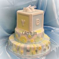 Baby Boy Block Buttercream icing with fondant box and circles. My first time making a box and booties. Candy melts decorations on the sides. I had a lot...