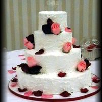 Stacked Round Four Layers The bride wanted the icing to look like stucco. Real roses were used to accent. This was my second wedding cake.