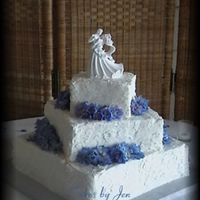 Square "stucco" Stacked 6" 10" 14" square stacked offset wedding cake. The bride wanted the stucco look. The flowers are delphiniums, which were...