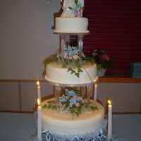 Firstcake This is my first wedding cake, it is covered in MMF and the flowers are gumpaste.