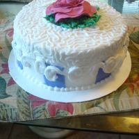 Dsc00754.jpg French vanilla with strawberry mousse filling and BC icing. Gumpaste flower, fondant stripe accents.