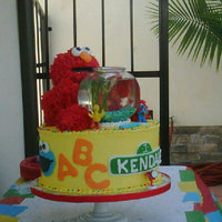 Chile's First Birthday Omg!! what a cake..this was super fun to make!! Yellow cake w/chocolate mousse filling...elmo was yellow cake as well..arms and legs where...